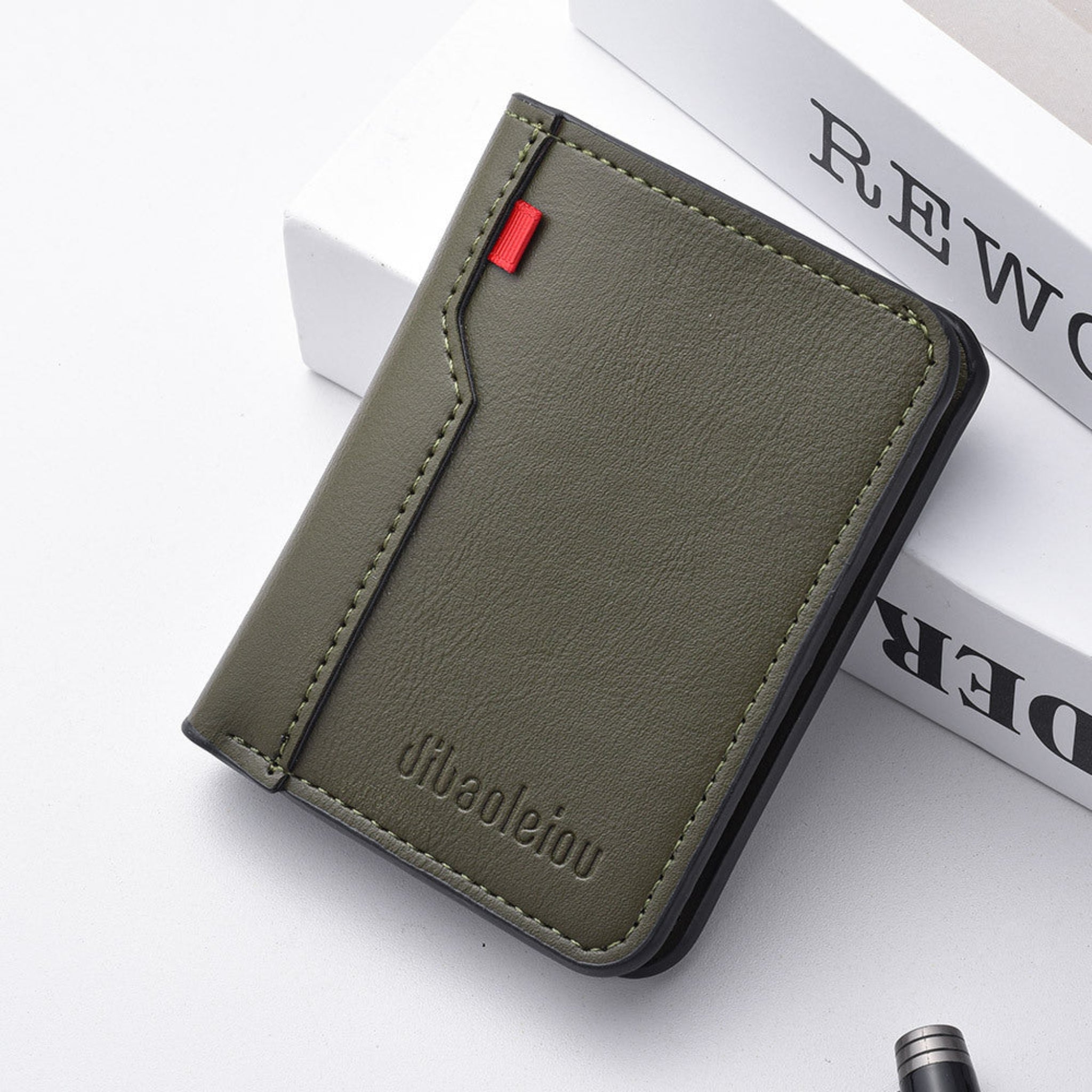 Green wallet with brand name on a white surface