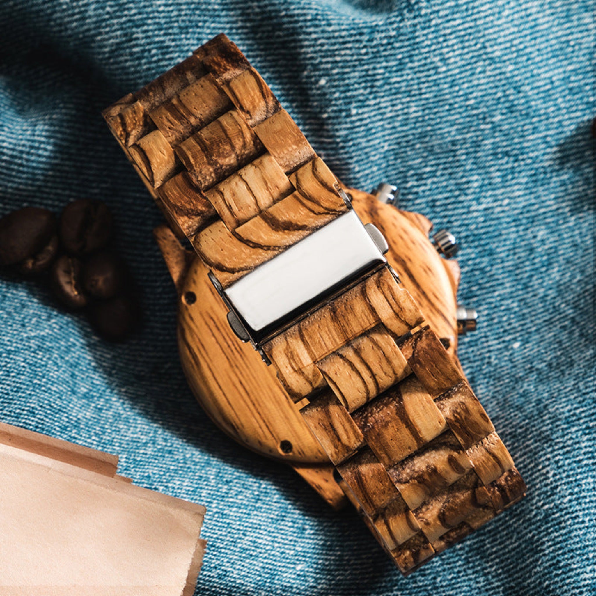 Wooden watch with braided strap on a denim background