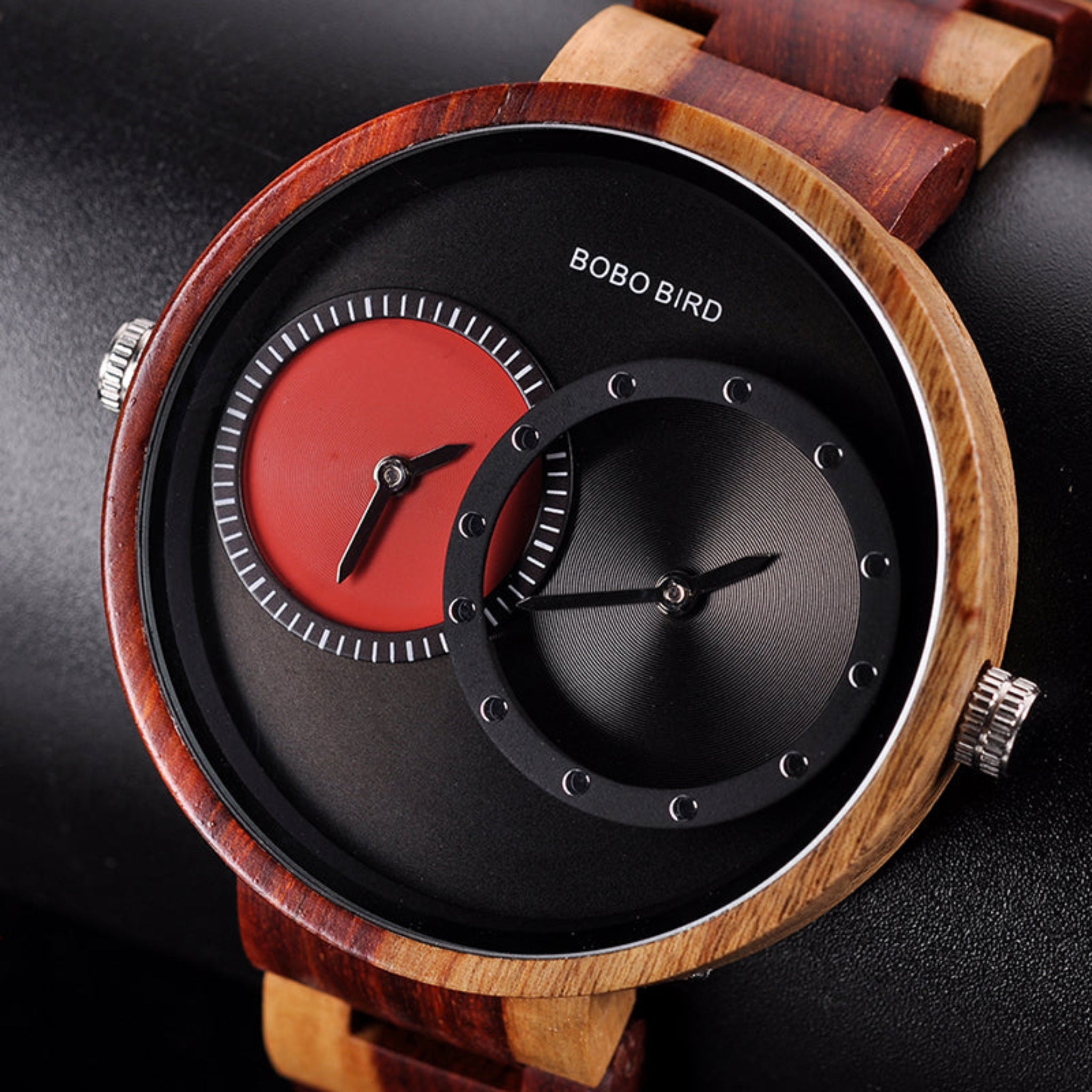 Wooden watch with a red and black face on a dark background