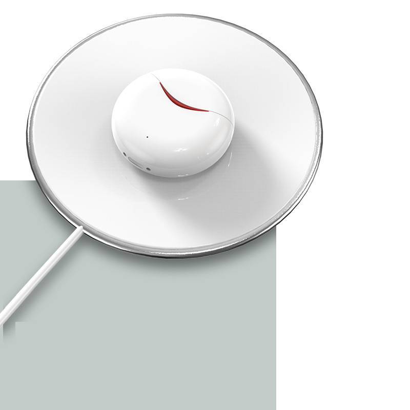 A pair of XT17 Earbuds in white, charging on a wireless charging station