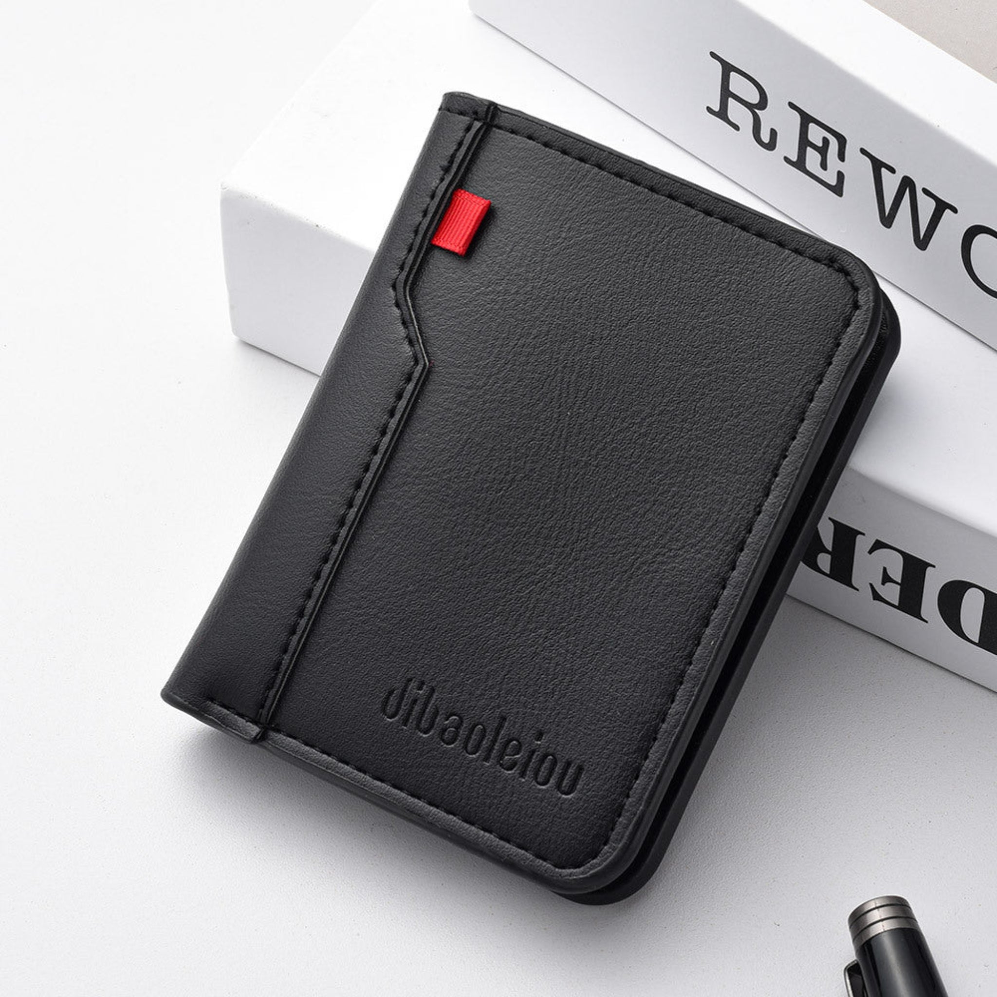 Black leather wallet with a red accent on a white surface