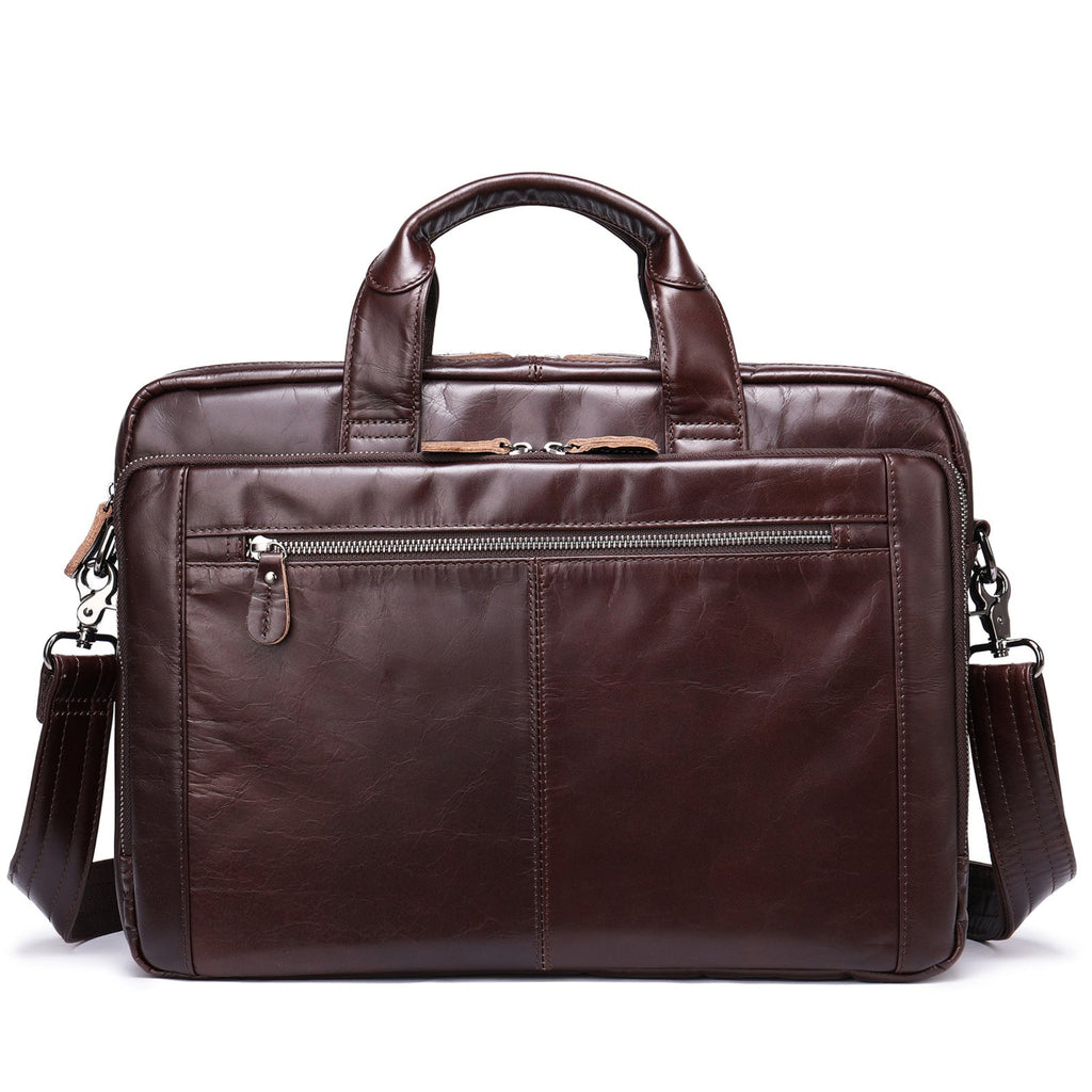 Brown leather briefcase with shoulder strap on a white background