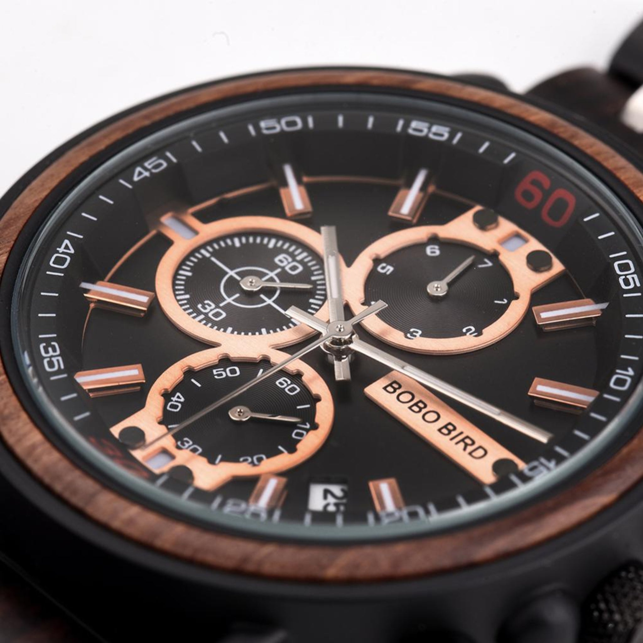 Close-up of a watch with a black face and rose gold accents, featuring the brand 'Bobo Bird'.