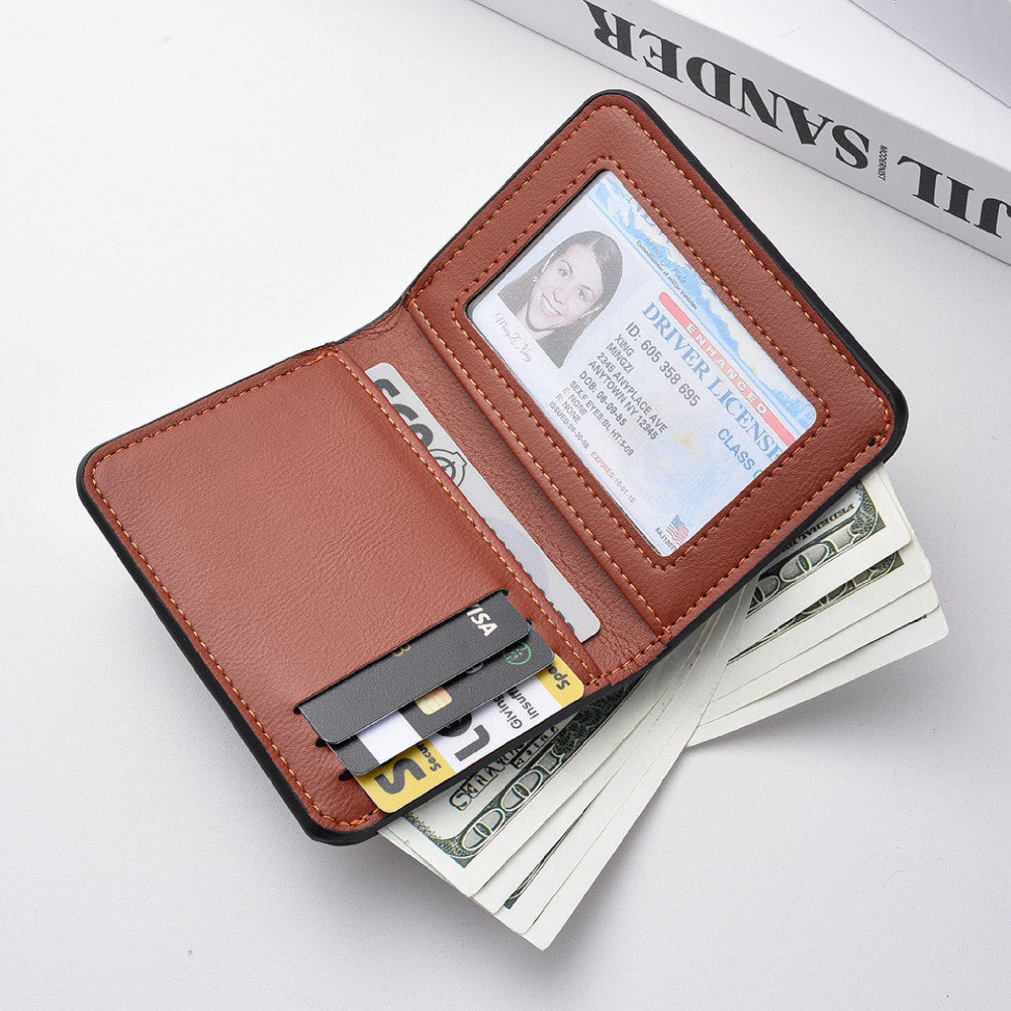 Brown leather wallet with cards and money on a white surface