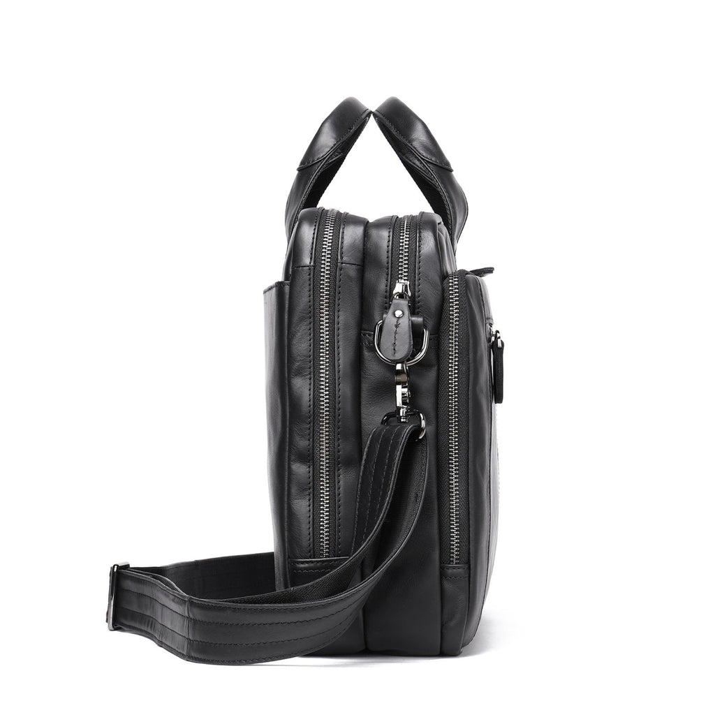 Black leather bag with multiple zippers on a white background