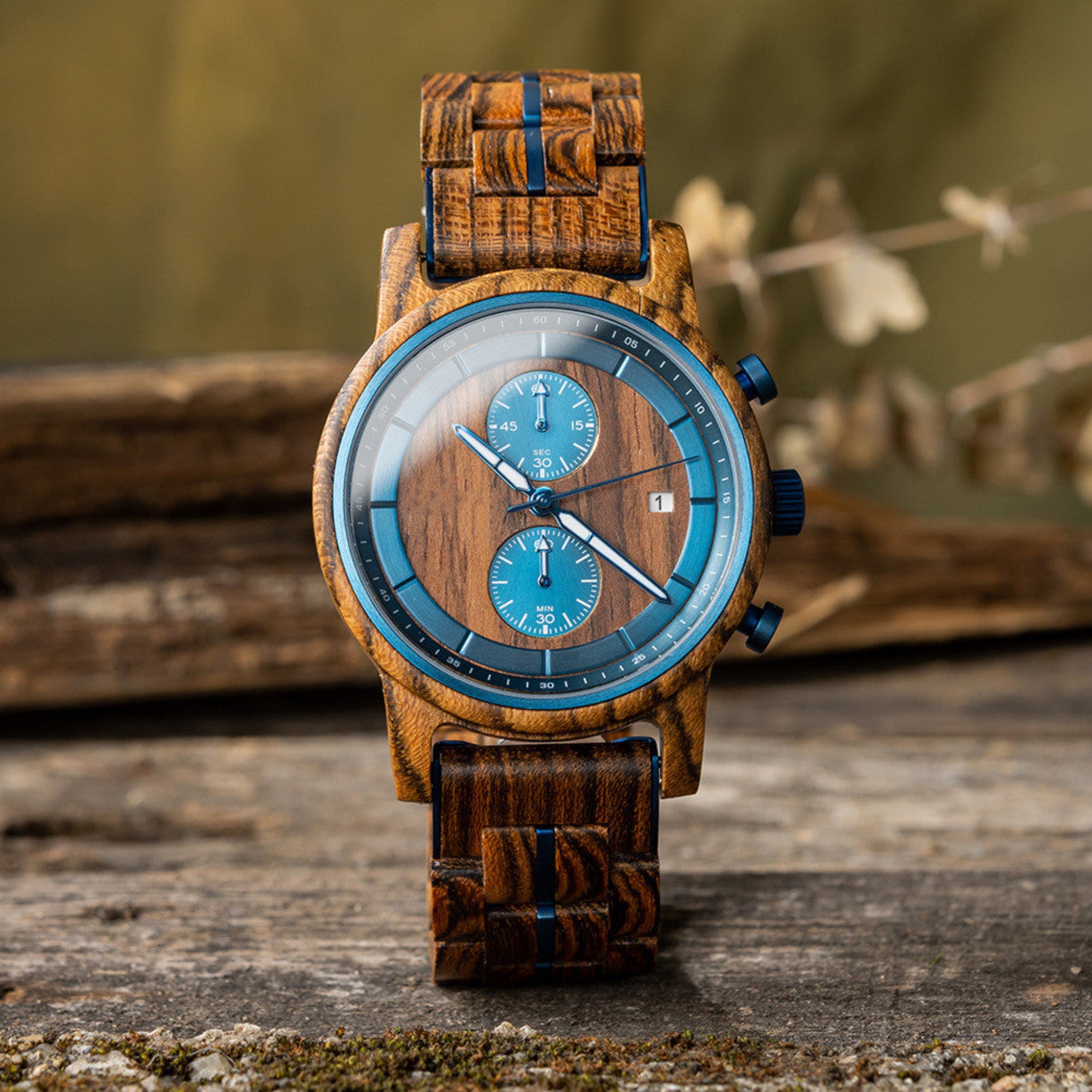 Wooden watch with blue face on a wooden surface